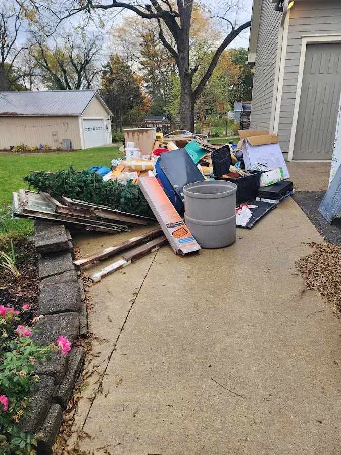 Dumpster being loaded with debris for 10 Yard Dumpster Rental in Leland